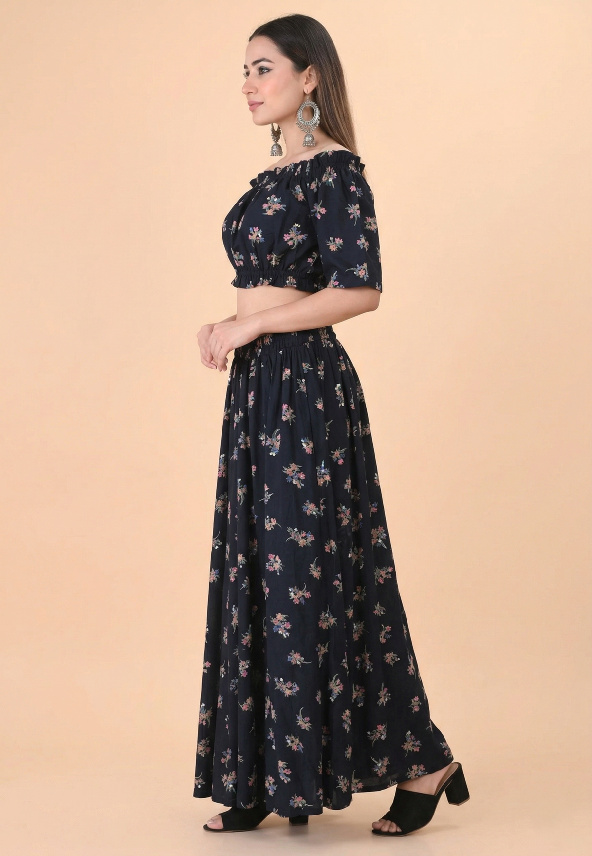 Side view of women black floral off shoulder co-ord set with long skirt