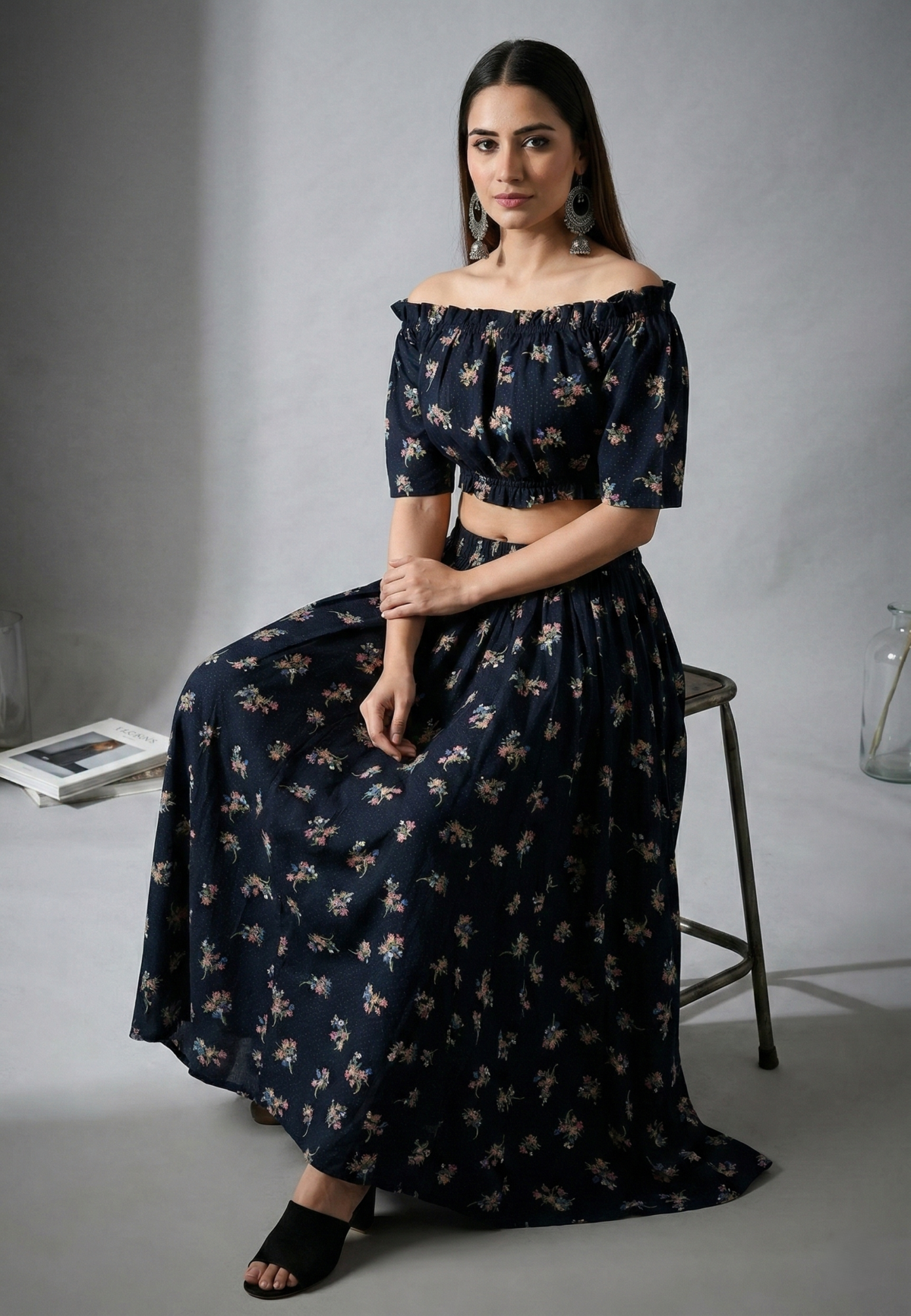 Side view of women black floral off shoulder co-ord set with long skirt
